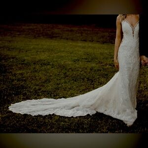 Size 0/2 off white fitted wedding dress with deep plunging neckline